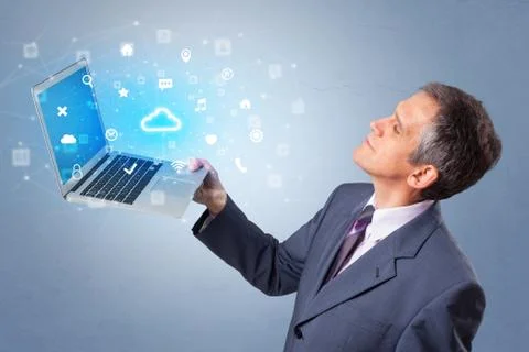 Man holding laptop with cloud based system notifications Stock Photos