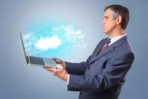 Man holding laptop with cloud based system notifications Stock Photos