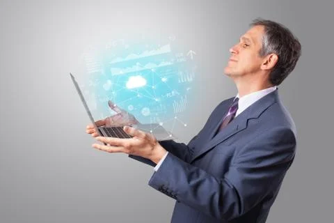 Man holding laptop with cloud based system concept Stock Photos