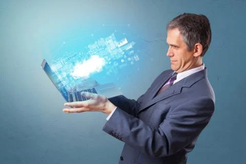 Man holding laptop with cloud based system notifications Stock Photos