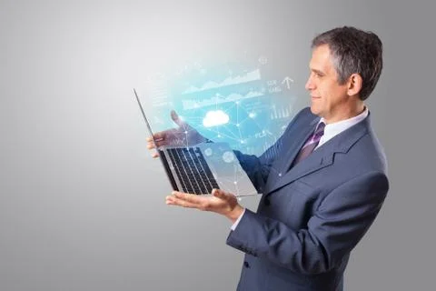 Man holding laptop with cloud based system concept Foto stock