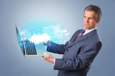 Man holding laptop with cloud based system notifications Foto stock