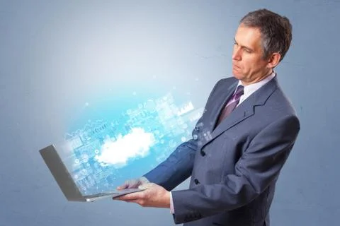 Man holding laptop with cloud based system notifications Stock Photos