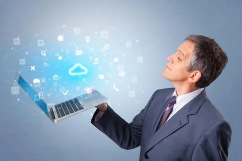 Man holding laptop with cloud based system notifications Stock Photos