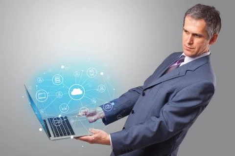 Man holding laptop with cloud based system concept Foto stock