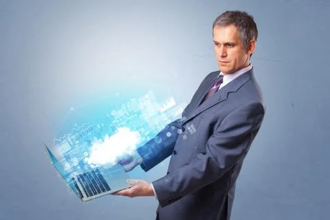 Man holding laptop with cloud based system notifications Foto stock