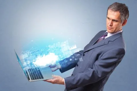 Man holding laptop with cloud based system notifications Stock Photos