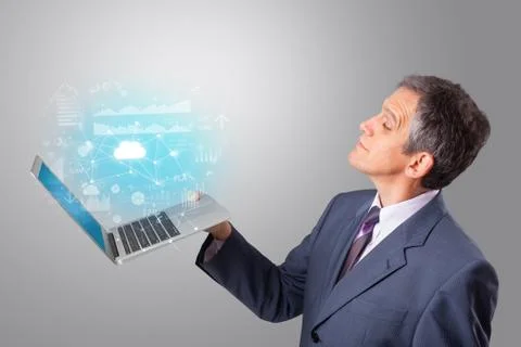 Man holding laptop with cloud based system concept Stock Photos