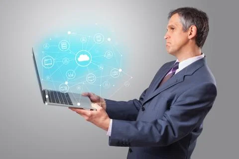 Man holding laptop with cloud based system concept Stock Photos