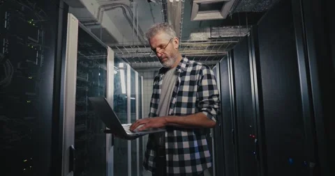 Man Holding Laptop in Server Room Stock Footage 277014376