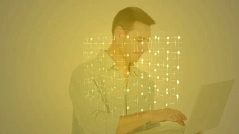 Man holding laptop, typing, creating glowing grid overlay in tech demo, smiling Stock Footage 327272558