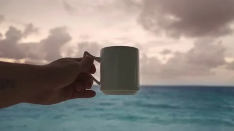 A man is holding a large mug of hot chocolate or coffee Video stock 146751591