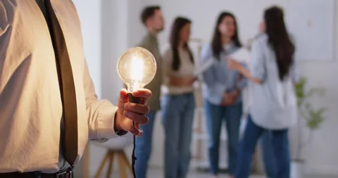 Man holding light bulb bright lamp as new idea, thinking alone, problem solution Stock Footage 282432609