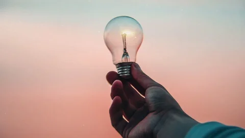 Man holding a light bulb concept and ideas 4K Stock Footage 98763804