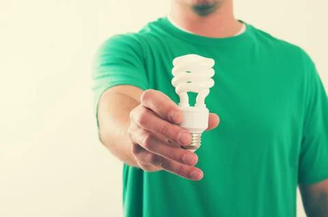 Man holding light bulb Stock Photos
