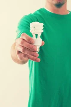 Man holding light bulb Stock Photos