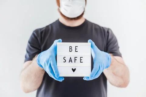 Man holding lightbox with text Be safe in his hand Foto stock