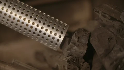 Man holding a looft lighter against the coal pieces Stock Footage 85965126