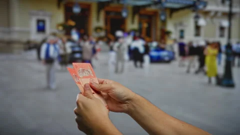 Man holding malaysian ringgit on busy urban street with people walking in t.. Stock Footage 303423959