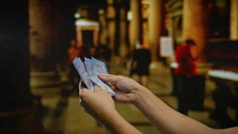 Man holding malaysian ringgits inside a dimly lit church, emphasizing curre.. Stock Footage 306403940