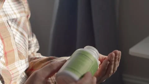 Man Holding Many Pills Taking One With Water Macro Stock Footage 330092485