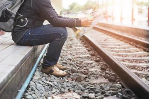 Man holding map with backpack at train station Stock Photos