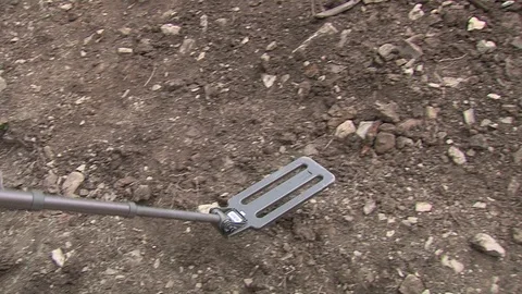 Man holding metal detector while searching for unexploded bombs lying in Stock Footage 105815553