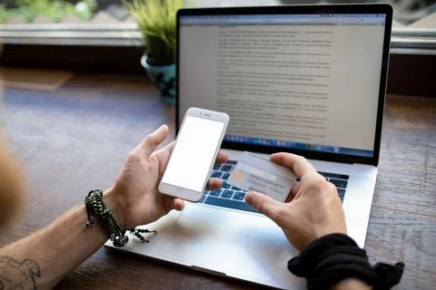 Man holding mobile phone with empty screen with copy space and credit card do Stock Photos