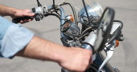 Man holding motorcycle handle with control buttons Stock Footage 136355149