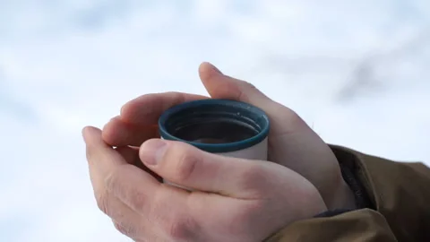 Man is holding a mug of tea Stock Footage 86371492