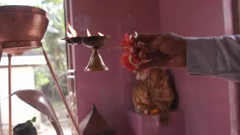 Man holding a oil lamp while praying at a temple in Kathmandu Stock-Footage 104432206