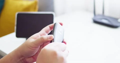 Man holding old mobile NOKIA 3310 try to use and touch button and check Stock Footage 197596088