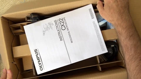 Man Holding Olympus CX22 Microscope Unboxed Stock Footage 306050421