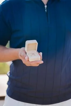 Man holding an open box with a diamond engagement ring for a proposal Stock Photos