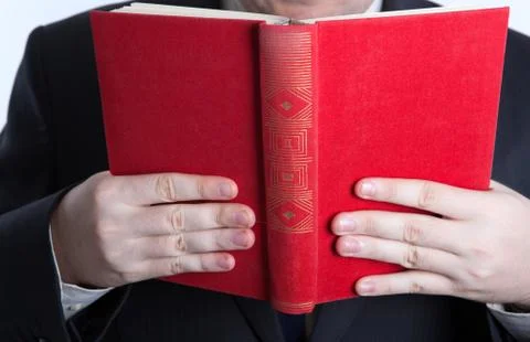 Man holding an open red book Stock Photos