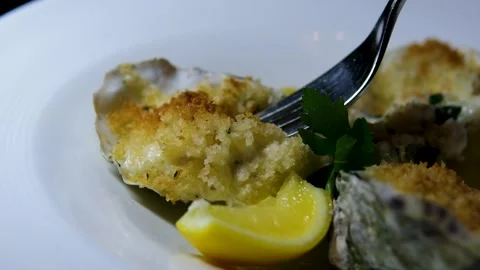 Man holding opened fresh raw oyster with squeezed lemon juice in hands and Stock Footage 302265112