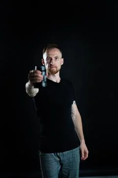 A man holding optics for a camera in a studio 스톡 사진