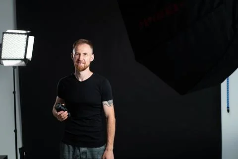 A man holding optics for a camera in a studio 写真素材