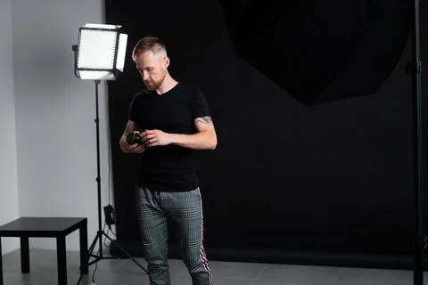 A man holding optics for a camera in a studio Photos
