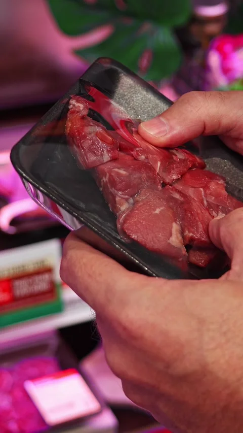 Man holding packaged pieces of beef in supermarket Stock Footage 331470826