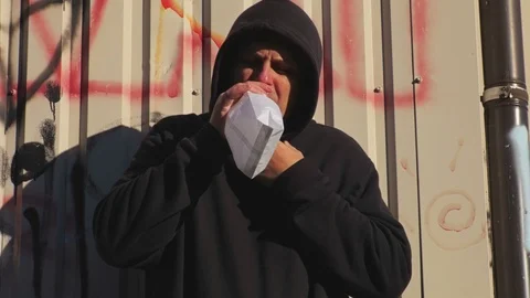 Man holding paper bag over mouth as if having a panic attack Stock Footage 95955435