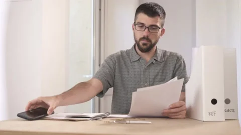 Man holding papers reading and solving problems 動画素材 130902949