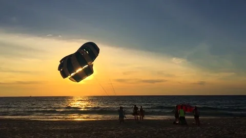 Man Holding a Parachute in the Wind on the Beach During Sunset. Karon beach 動画素材 72580594
