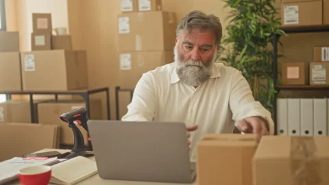 Man holding parcel at desk scanning package with handheld scanner in a buil.. Stock Footage 339201379
