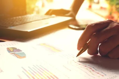 Man holding pen and thinking calculate cost and expenses and using laptop f.. Stock Photos