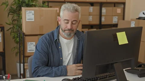 Man holding pen with hand at computer desk sorting parcels and checking lab.. Stock Footage 337437100
