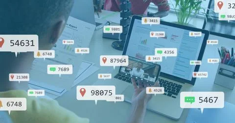 Man holding phone causing alert bubbles spreading settling receding over laptop Stockfoto's