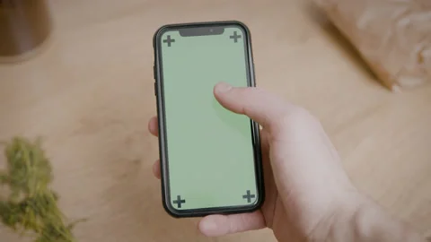 Man Holding A Phone In Kitchen Scrolling On Green Screen Background Stock Footage 162380882