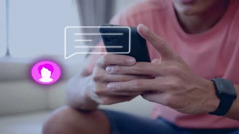 Man holding phone on sofa, pink avatar showing new chat, bubble shifting, thumbs Stock Footage 335761648