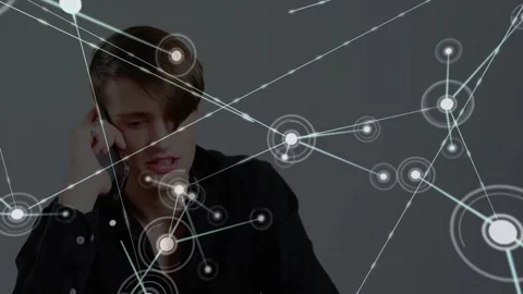 Man holding phone talking on glancing network nodes expanding overlaying face Stock Footage 334316242